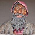 ceramics sculpture of homeless man squinting in the sunlight